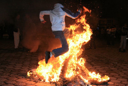 Participants jump through the flames three times for good luck